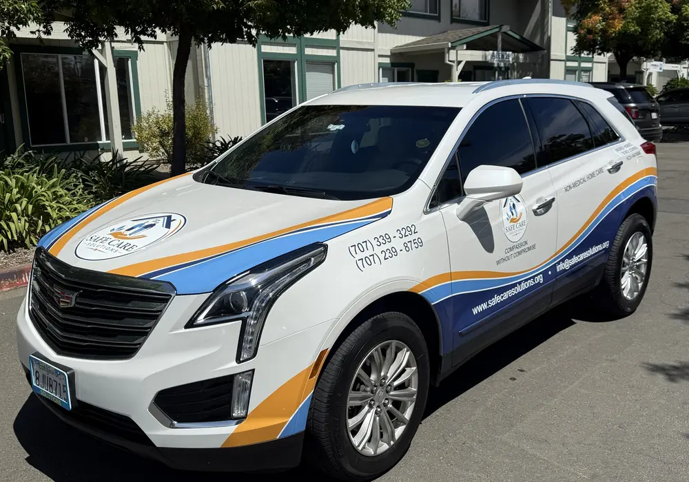 a company vehicle wrapped with a vinyl graphics showing company details