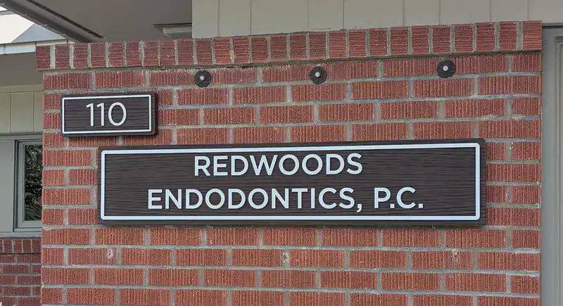 sandblasted address sign installed on a brick wall